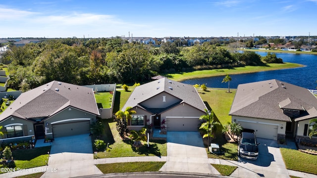 drone / aerial view featuring a water view and a residential view