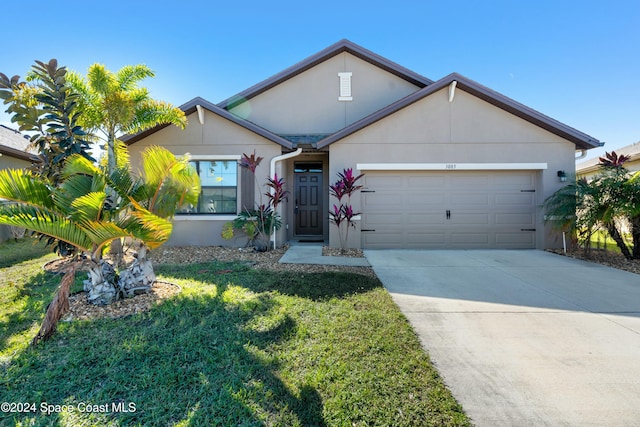 view of front of property with a garage and a front yard