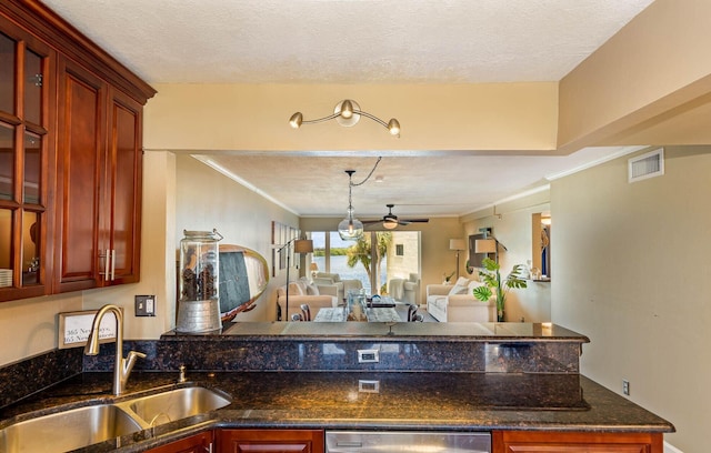 kitchen with ceiling fan, sink, and a textured ceiling