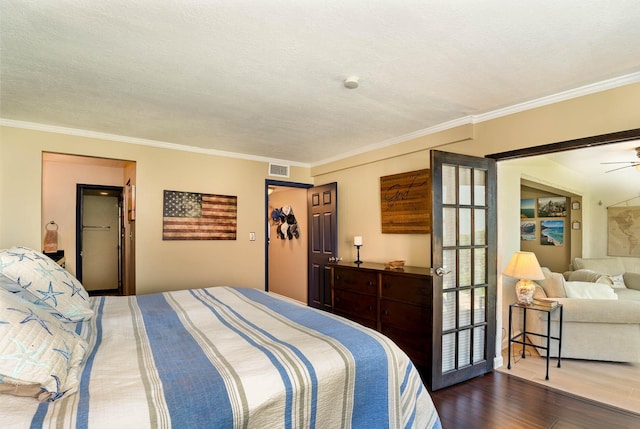 bedroom with a textured ceiling, crown molding, a closet, and dark wood-type flooring