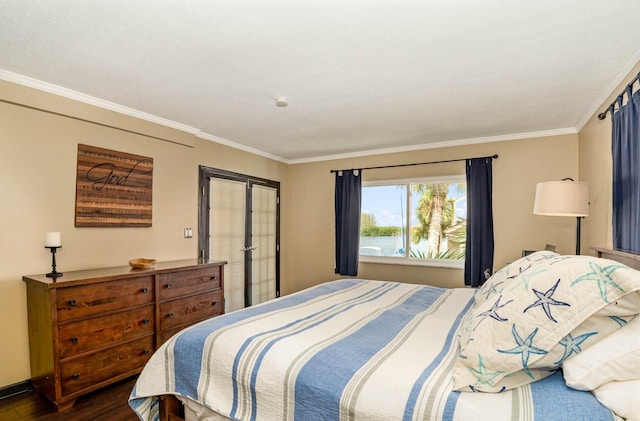 bedroom with dark hardwood / wood-style floors and ornamental molding