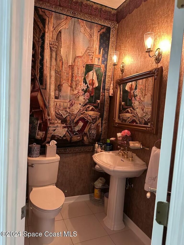 bathroom featuring sink, tile patterned floors, and toilet