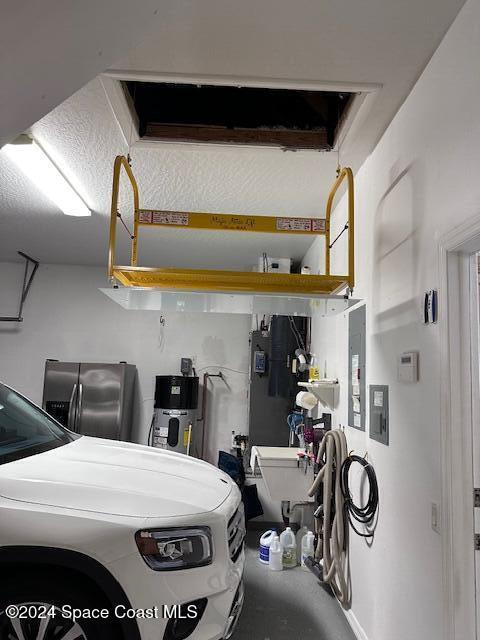 garage featuring stainless steel fridge and separate washer and dryer