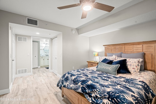 bedroom with connected bathroom, ceiling fan, and light wood-type flooring