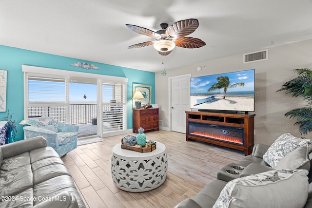 living room with ceiling fan and light hardwood / wood-style flooring