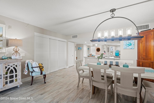 dining area with light hardwood / wood-style floors