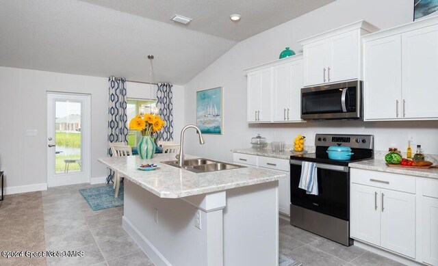1654 Middlebury Dr SE, Palm Bay, FL 32909 - kitchen with appliances with stainless steel finishes, a sink, lofted ceiling, a kitchen island with sink, and white cabinetry
