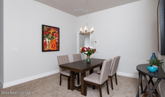 1654 Middlebury Dr SE, Palm Bay, FL 32909 - dining room featuring a chandelier, baseboards, and light carpet