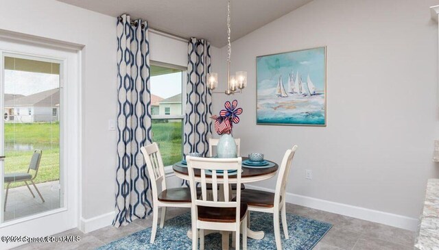 1654 Middlebury Dr SE, Palm Bay, FL 32909 - dining area with lofted ceiling, plenty of natural light, a chandelier, and baseboards