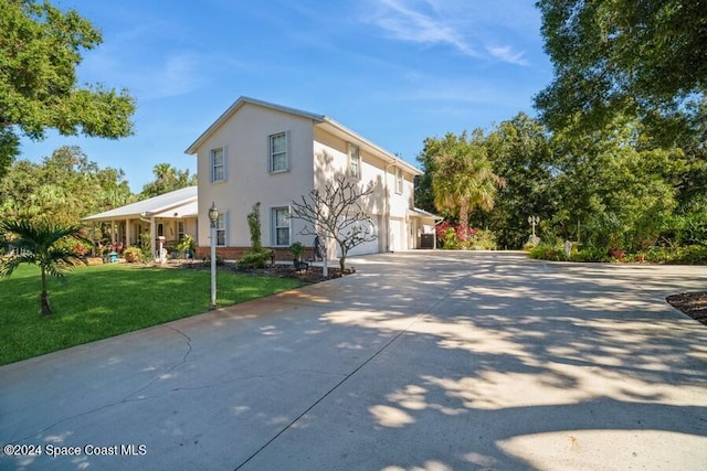 view of property exterior with a lawn and a garage