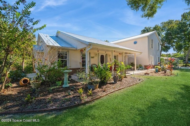 rear view of house featuring a lawn