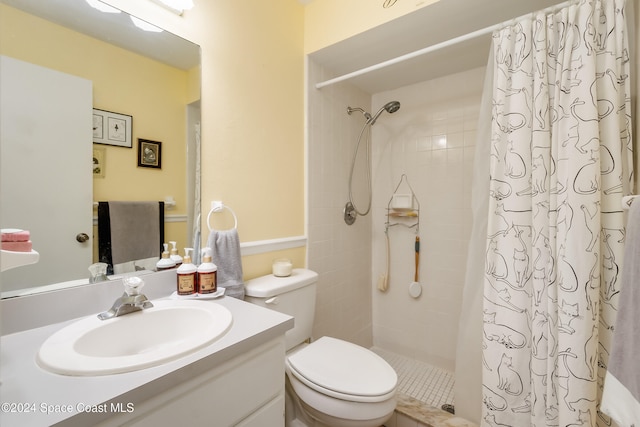 bathroom with curtained shower, vanity, and toilet