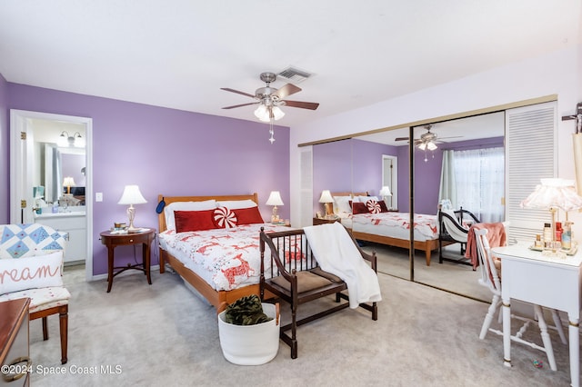 bedroom with ceiling fan, a closet, and light colored carpet