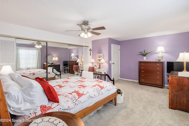 bedroom with light carpet, a closet, and ceiling fan