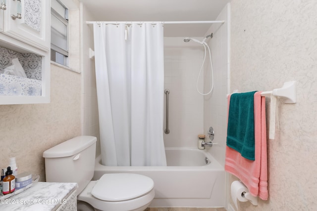 bathroom featuring shower / tub combo and toilet