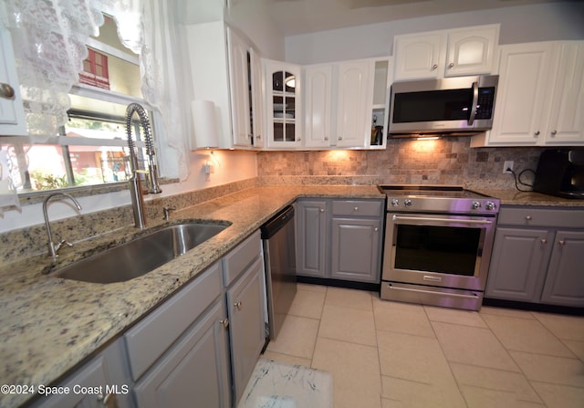 kitchen with white cabinetry, sink, stainless steel appliances, tasteful backsplash, and gray cabinets