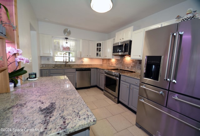 kitchen with white cabinets, stainless steel appliances, gray cabinets, and sink