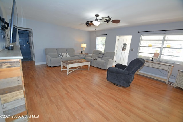 living room with ceiling fan and light hardwood / wood-style floors