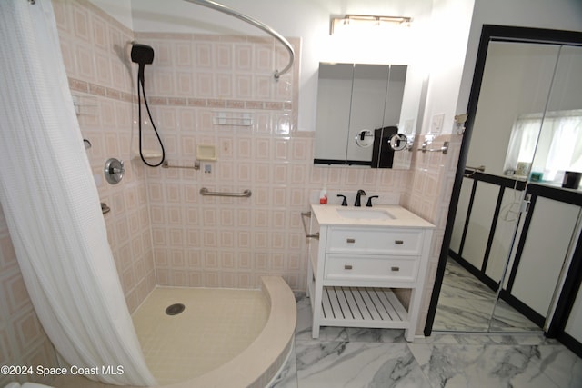 bathroom featuring vanity, curtained shower, and tile walls