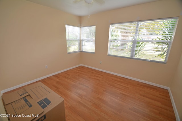 unfurnished room with hardwood / wood-style flooring and ceiling fan