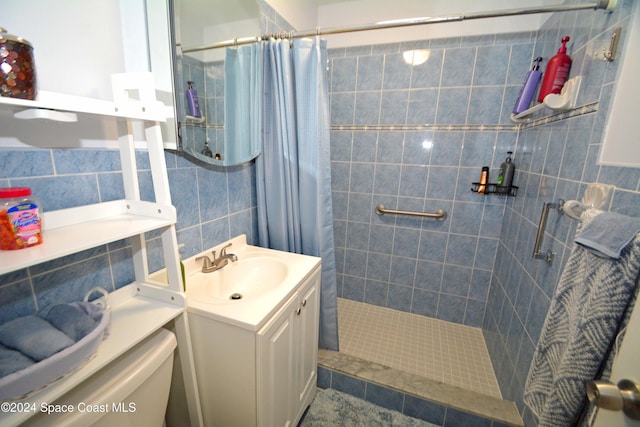 bathroom with toilet, vanity, tile walls, and a shower with shower curtain