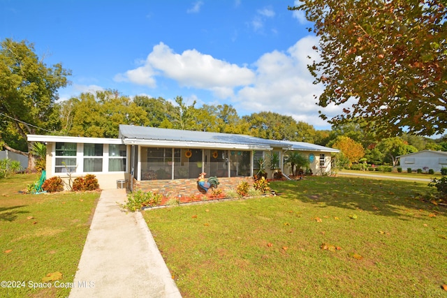 ranch-style house with a sunroom and a front yard