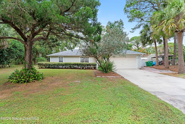 single story home featuring a garage and a front lawn