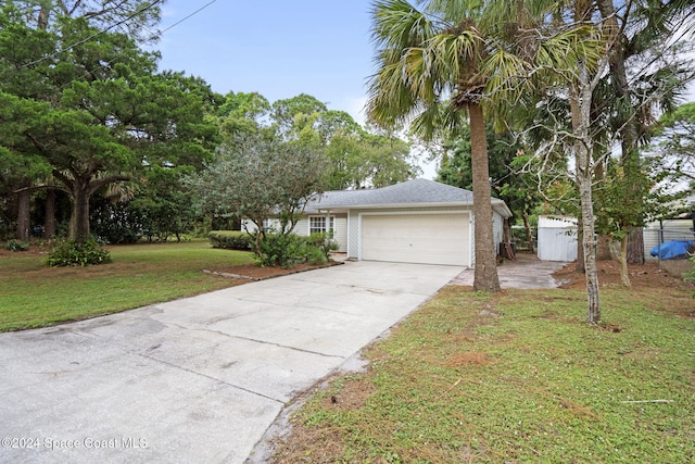 view of front of home featuring a shed, a garage, and a front lawn