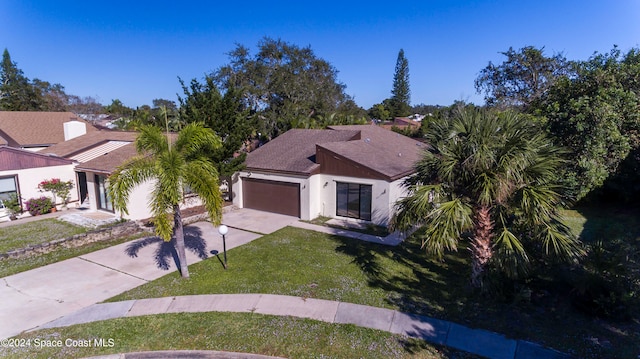 view of front of home featuring a front yard and a garage