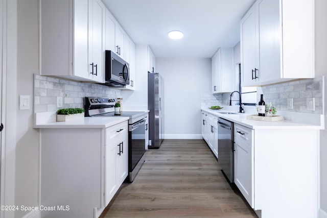 kitchen featuring white cabinetry, light hardwood / wood-style flooring, and appliances with stainless steel finishes