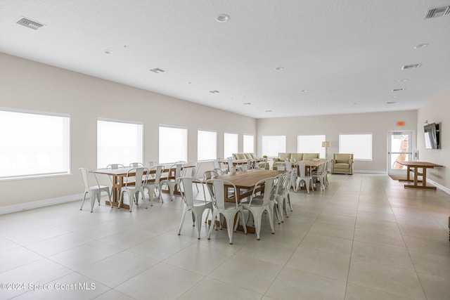 dining room with plenty of natural light and light tile patterned floors