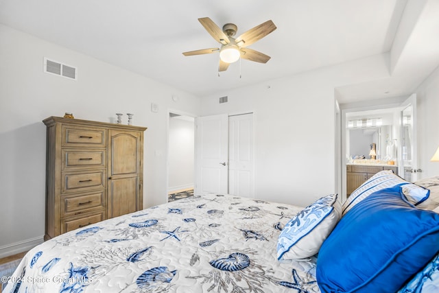 bedroom with ensuite bath, ceiling fan, a closet, and hardwood / wood-style flooring