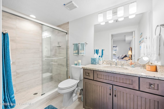 bathroom featuring walk in shower, a textured ceiling, toilet, vanity, and hardwood / wood-style flooring