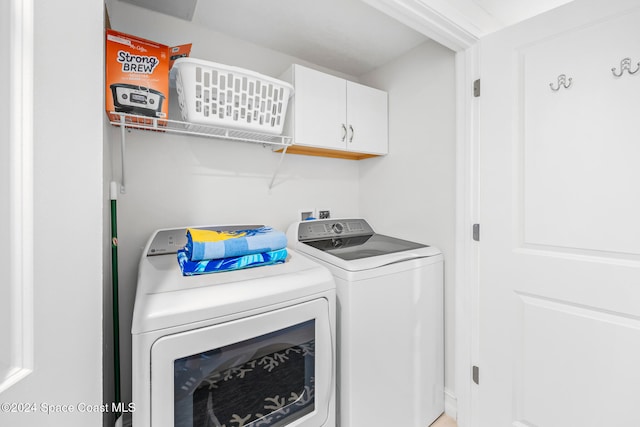 laundry area featuring cabinets and washing machine and dryer