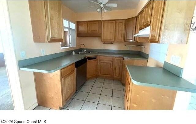 kitchen featuring dishwasher, ceiling fan, light tile patterned flooring, and sink