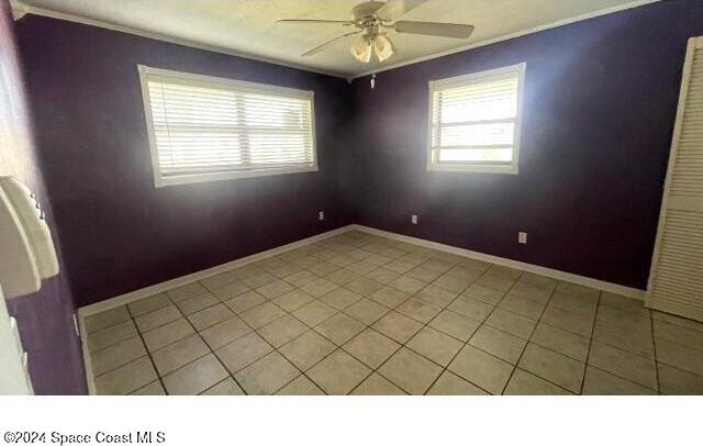 361 Payne Ave, Cocoa, FL 32927 - unfurnished room with crown molding, a ceiling fan, healthy amount of natural light, baseboards, and light tile patterned flooring