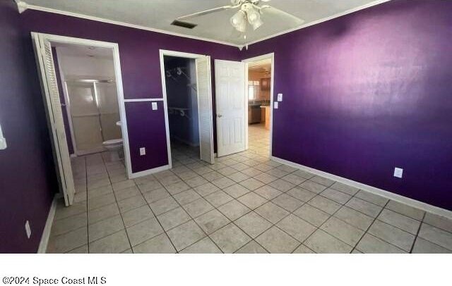 361 Payne Ave, Cocoa, FL 32927 - unfurnished bedroom featuring baseboards, ornamental molding, a closet, light tile patterned flooring, and ceiling fan