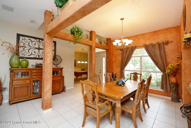 dining room with a notable chandelier and light tile patterned floors