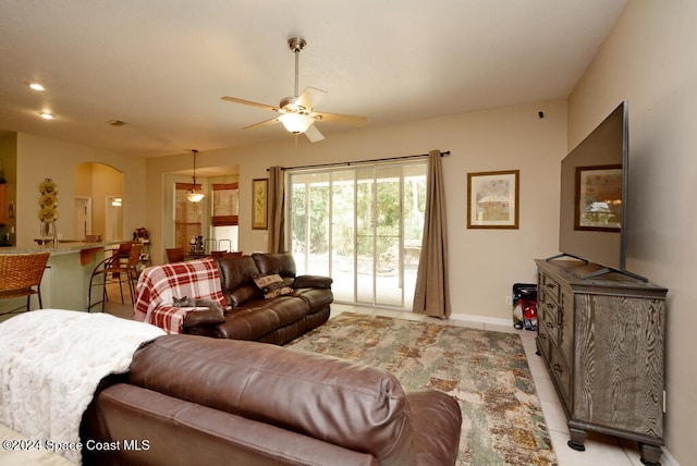 tiled living room featuring ceiling fan