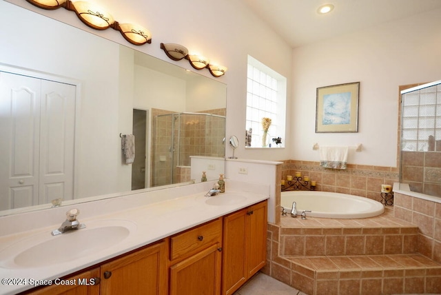 bathroom featuring vanity and independent shower and bath