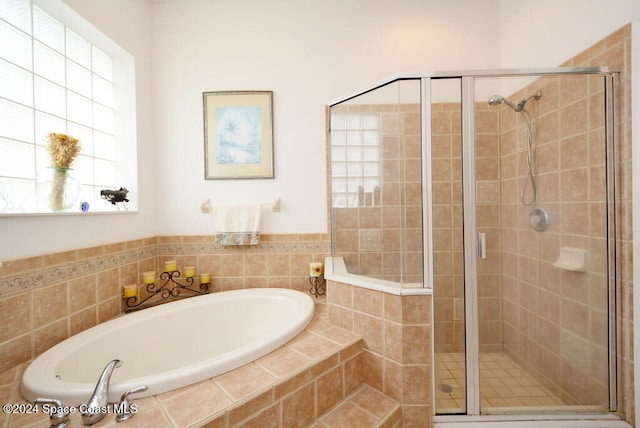 bathroom with separate shower and tub