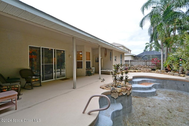 view of patio / terrace with a fenced in pool