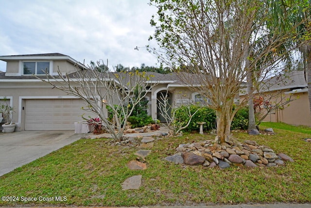 view of front of home featuring a garage and a front lawn