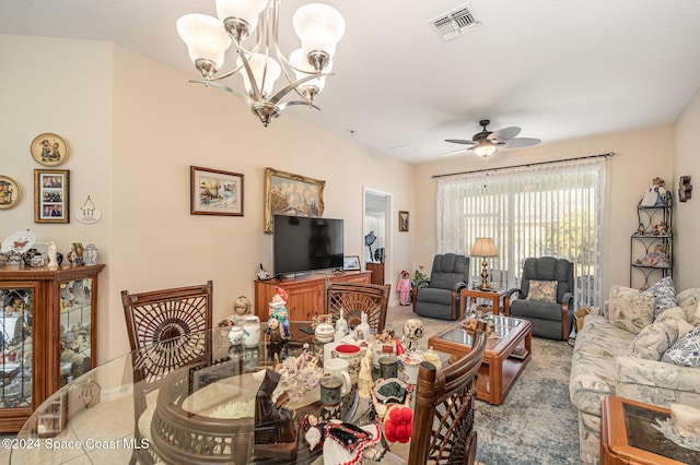 dining space with ceiling fan with notable chandelier and light tile patterned flooring