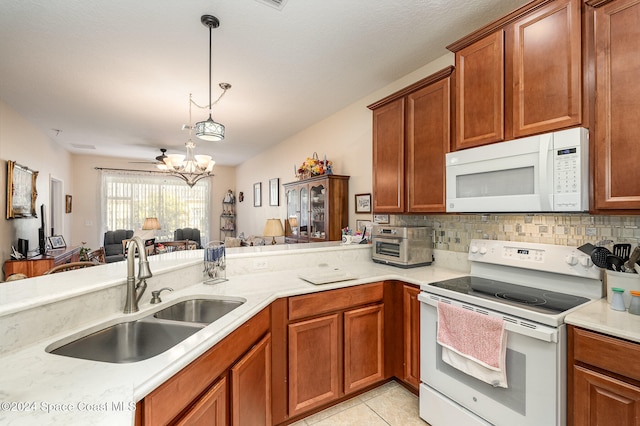 kitchen featuring kitchen peninsula, white appliances, sink, pendant lighting, and light tile patterned floors