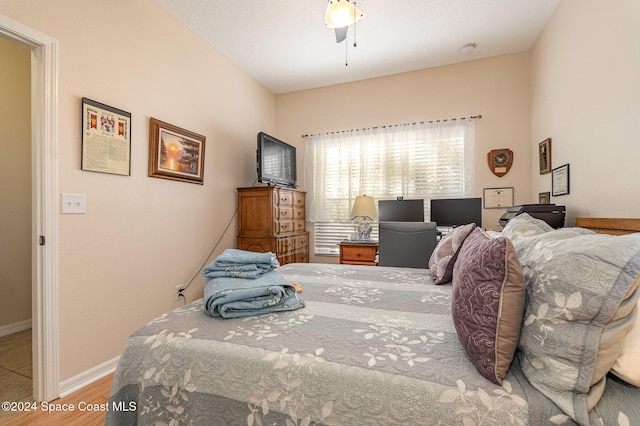 bedroom with ceiling fan and wood-type flooring