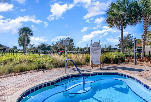 view of swimming pool featuring a community hot tub