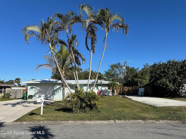 view of front of house with a garage and a front lawn