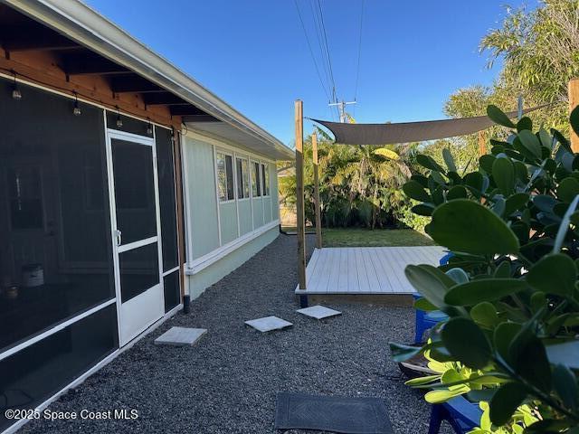 view of yard with a wooden deck and a sunroom