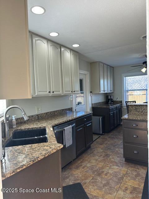 kitchen with white cabinets, ceiling fan, sink, stone counters, and dishwasher